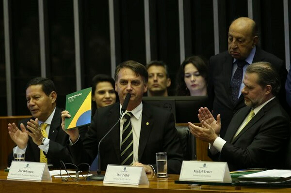 Bolsonaro segurando a Constituição do Brasil